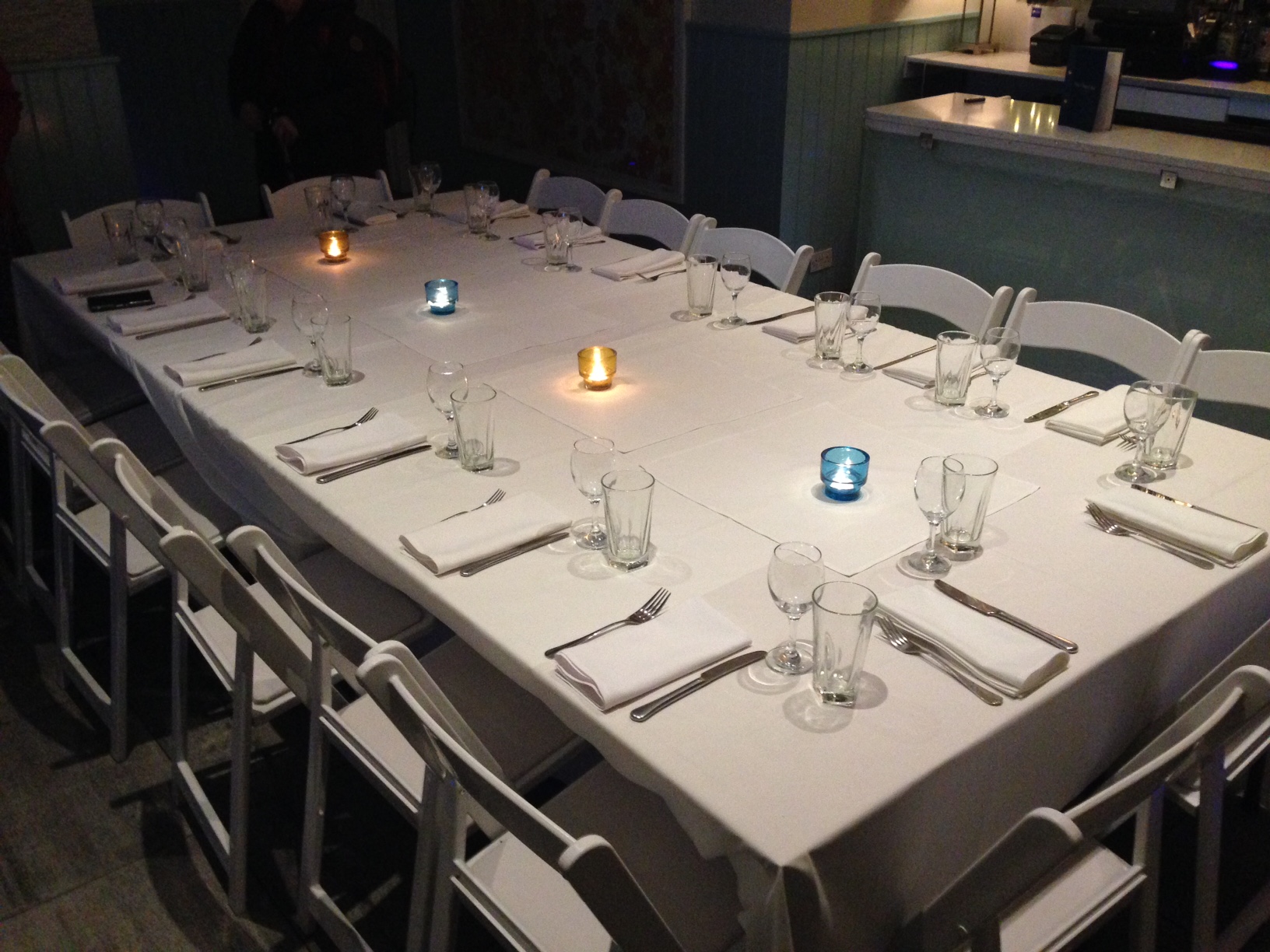 Intimate dining setup with white linens in The Terrace Room, ideal for meetings and gatherings.