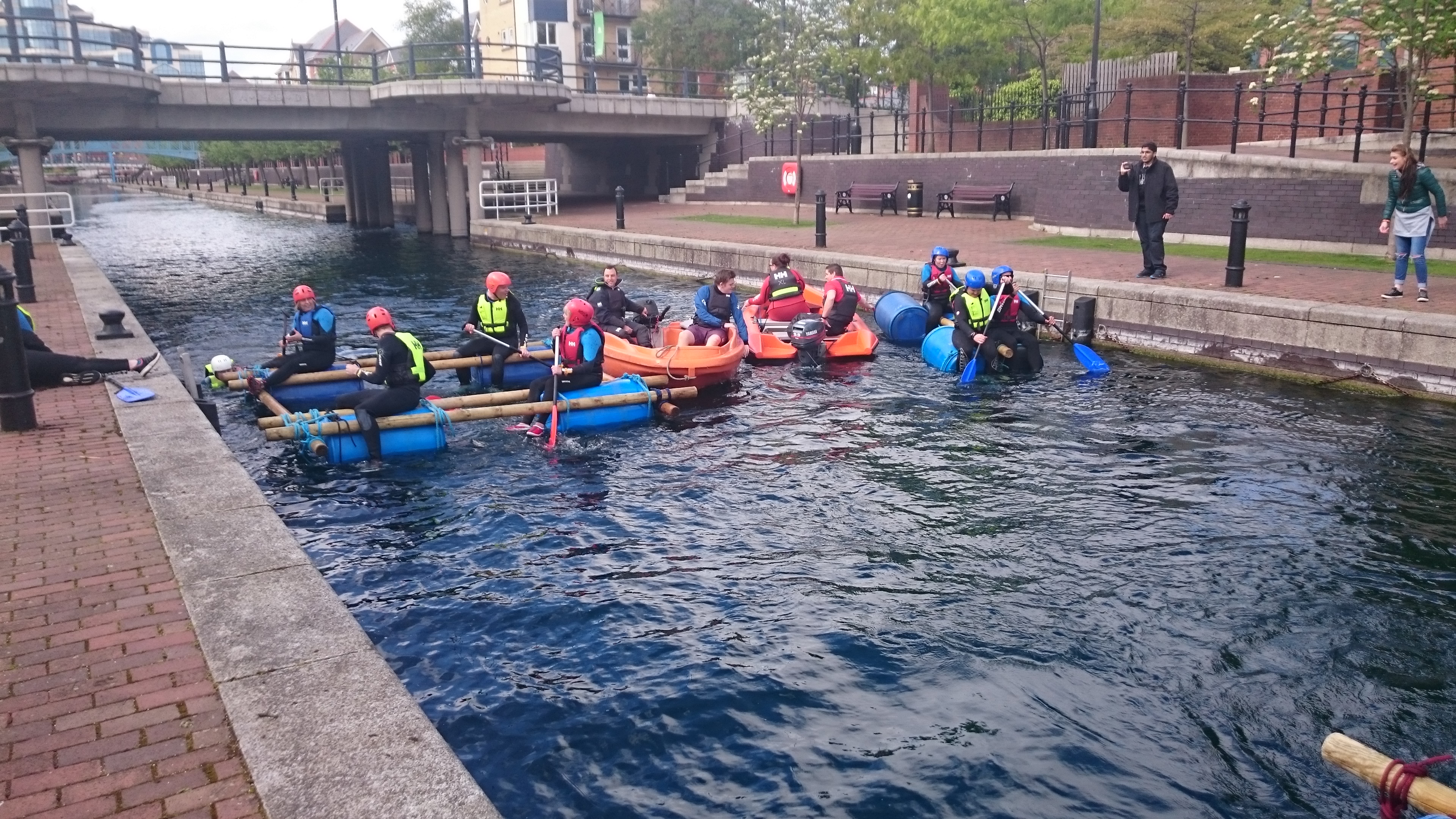 Team-building event at Helly Hansen Watersports Centre with colorful kayaks on water.