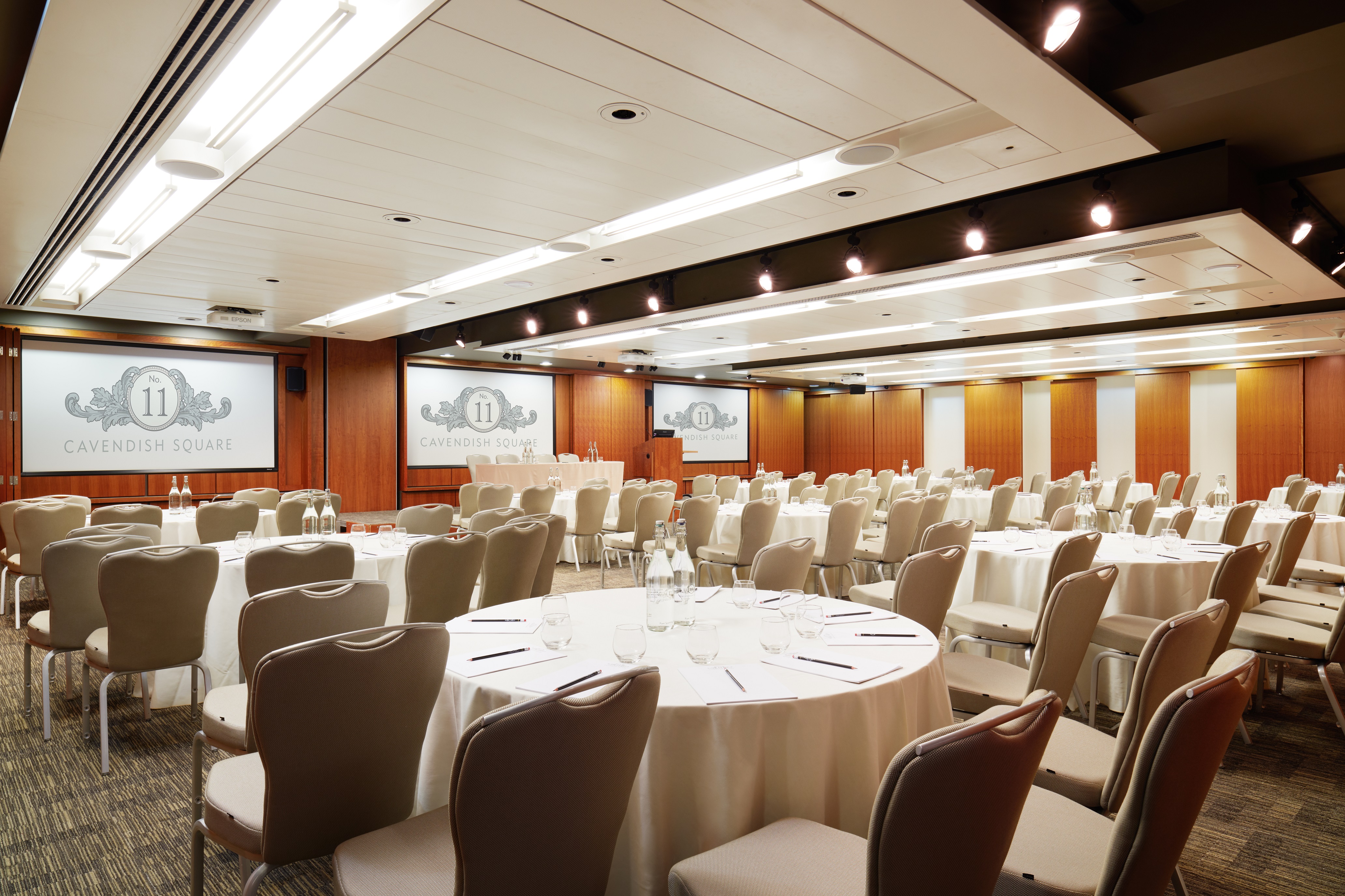 Burdett Suite conference room with round tables, ideal for corporate meetings and seminars.