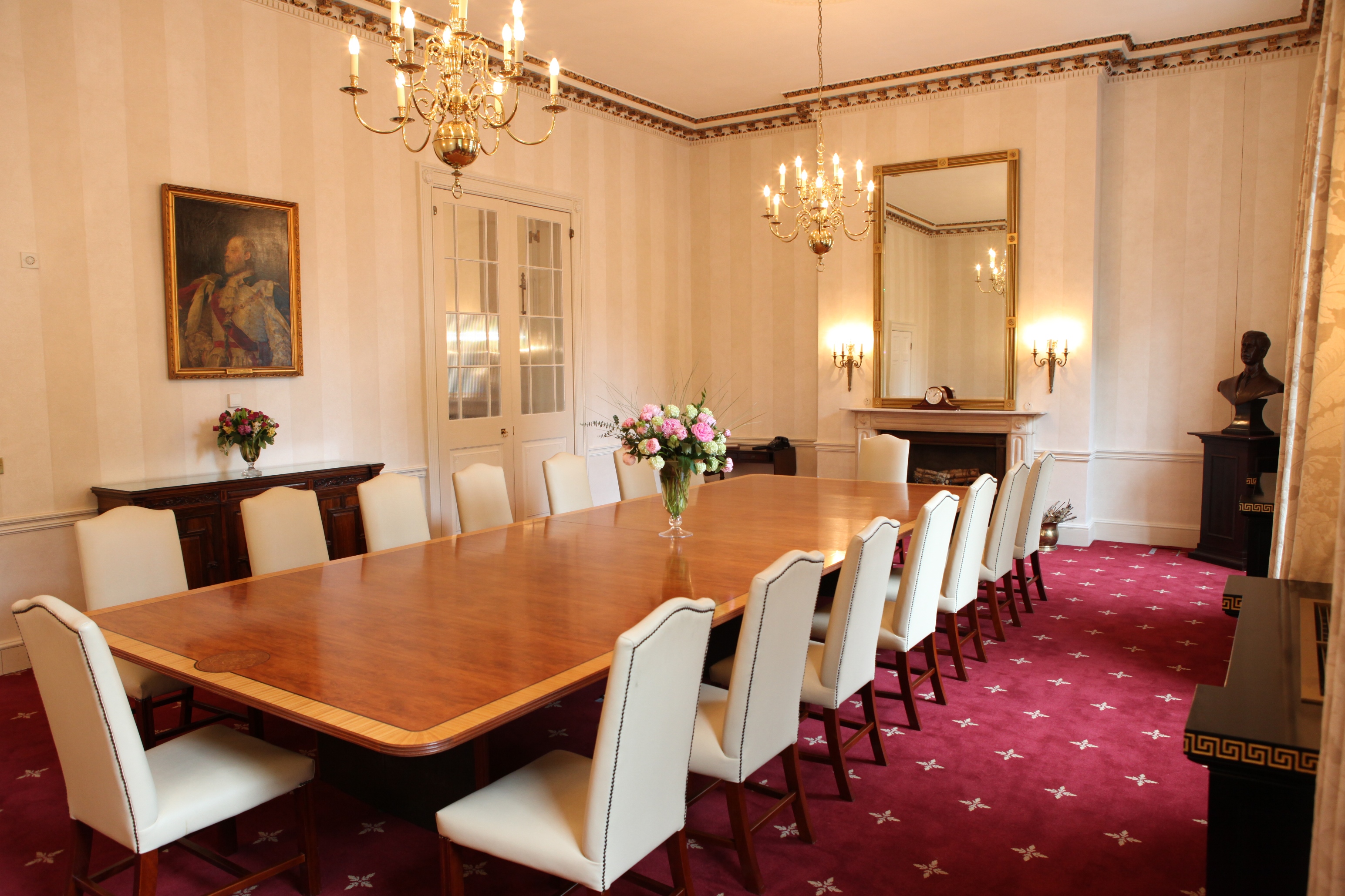 Elegant meeting room with wooden table, perfect for executive meetings and events.