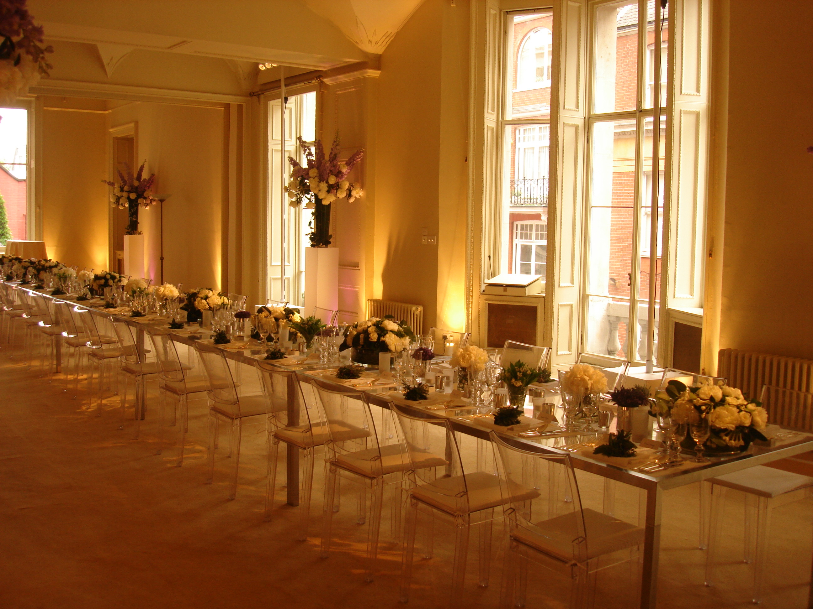 Elegant North Sanctuary event space with acrylic table, ideal for formal dinners and corporate events.
