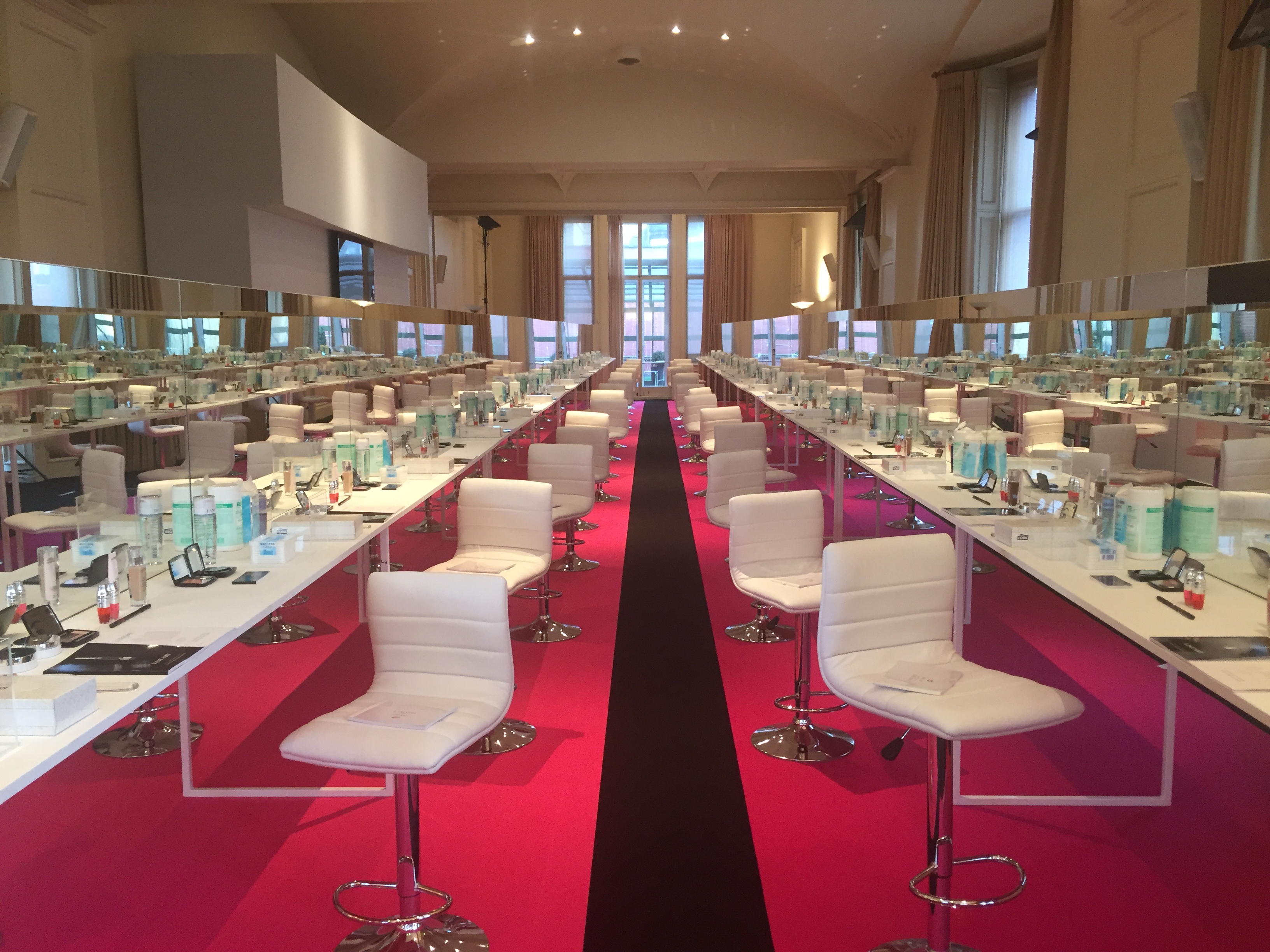 North Sanctuary event space with white tables, pink carpet for workshops and presentations.