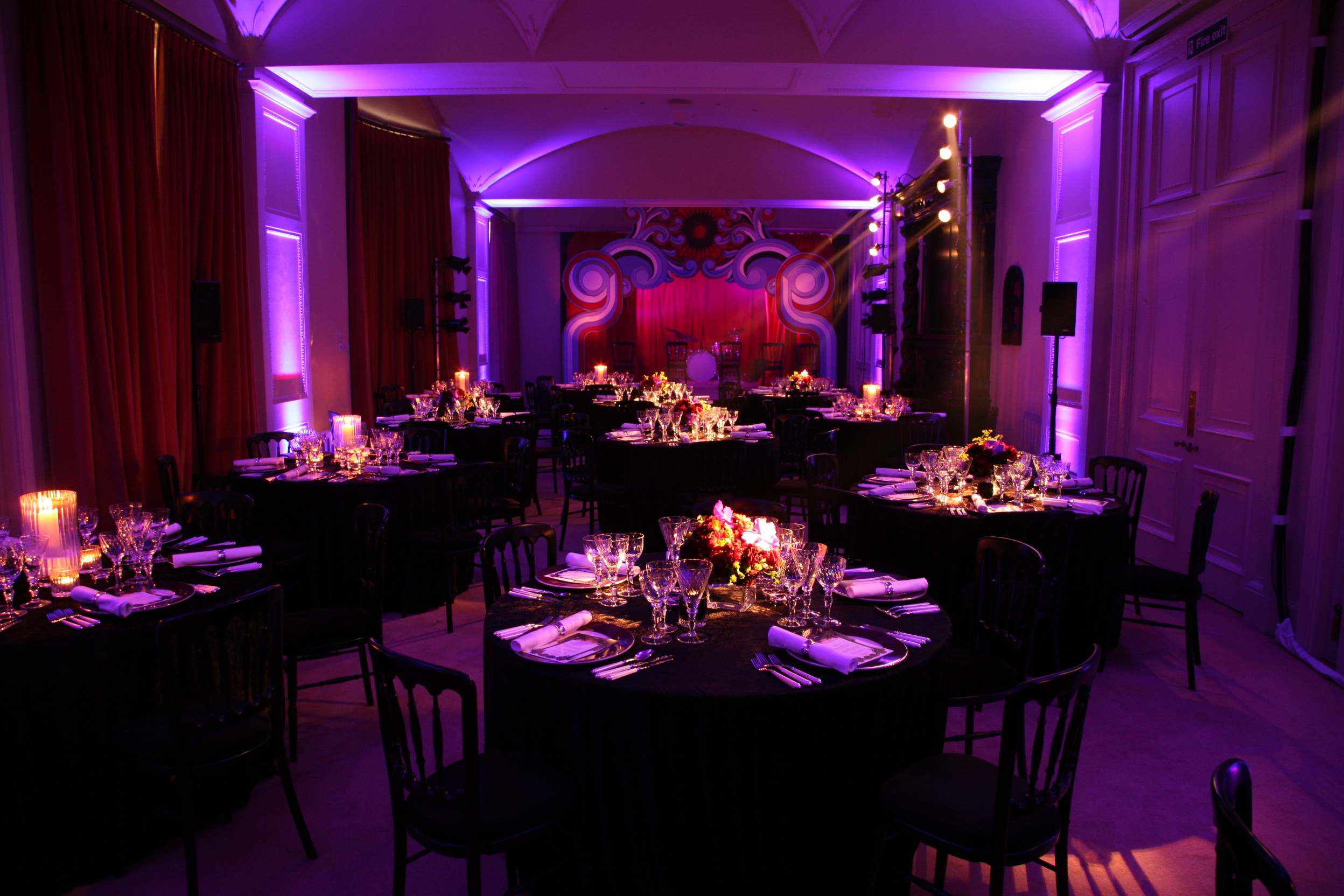 Elegant event space in Kent House with round tables and purple lighting for galas.