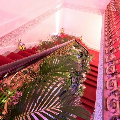 Elegant staircase with greenery in Marble Hall, ideal for weddings and corporate events.
