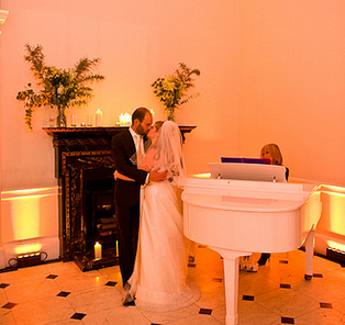 Couple's first dance in Marble Hall, Kent House; elegant wedding venue with live music.