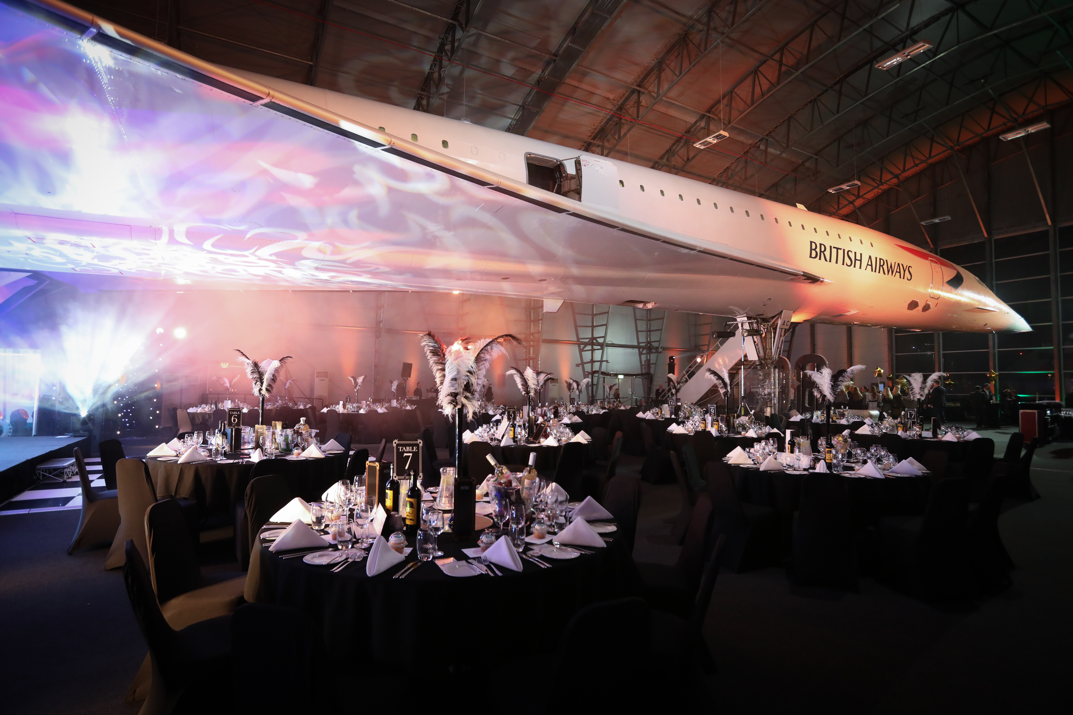 Concorde Hangar event space with iconic aircraft backdrop for corporate gatherings and gala dinners.