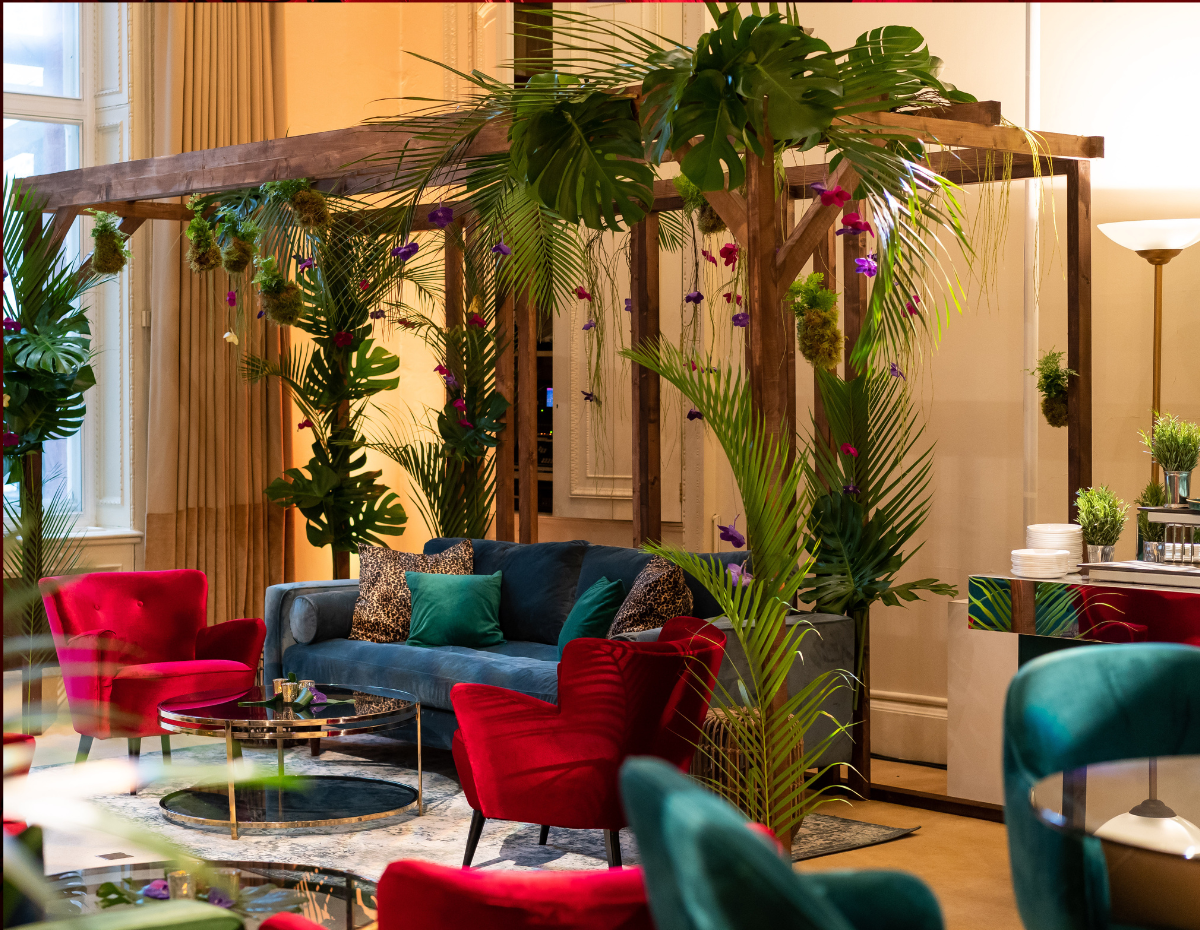 Stylish event space in Kent House with vibrant seating and lush greenery for gatherings.