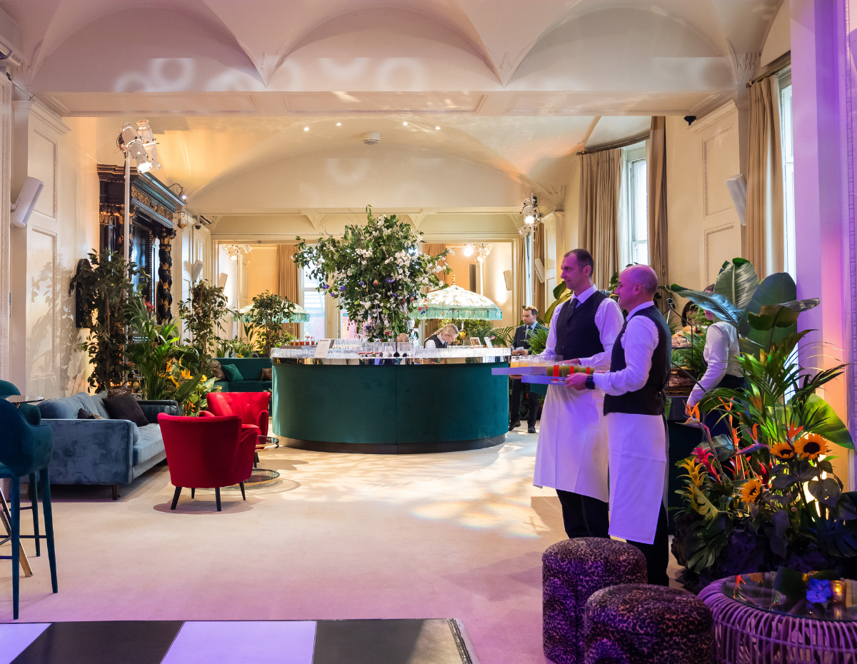 Elegant event space in Kent House Knightsbridge with lush greenery and bar area.
