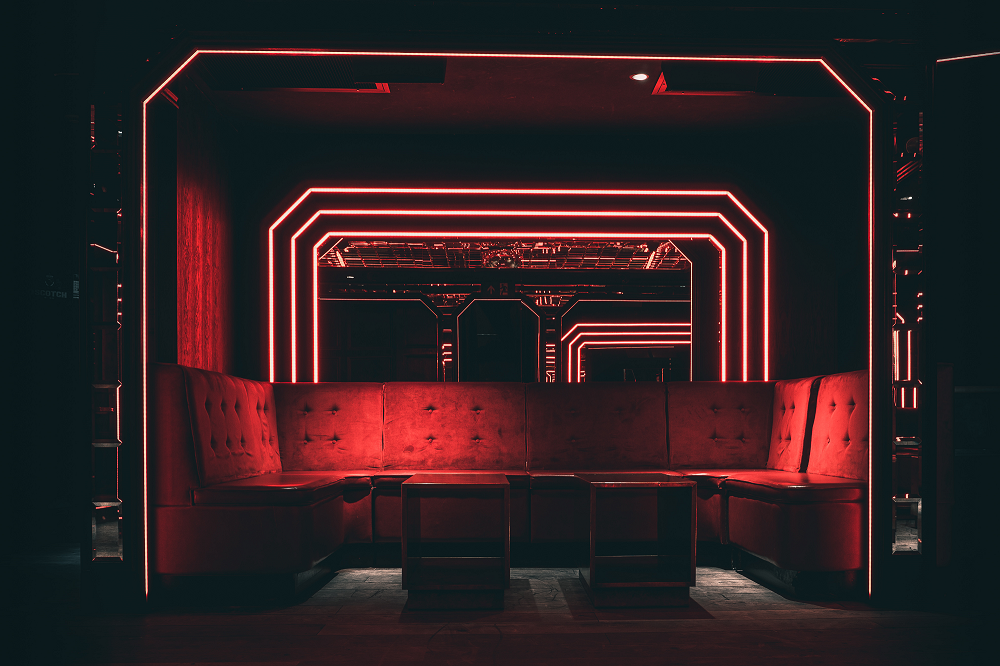 Stylish lounge with red neon lighting, perfect for networking events at The Scotch of St James.