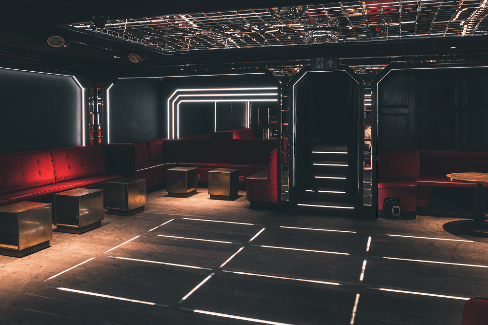 Modern event space at The Scotch of St James with red seating for gatherings.