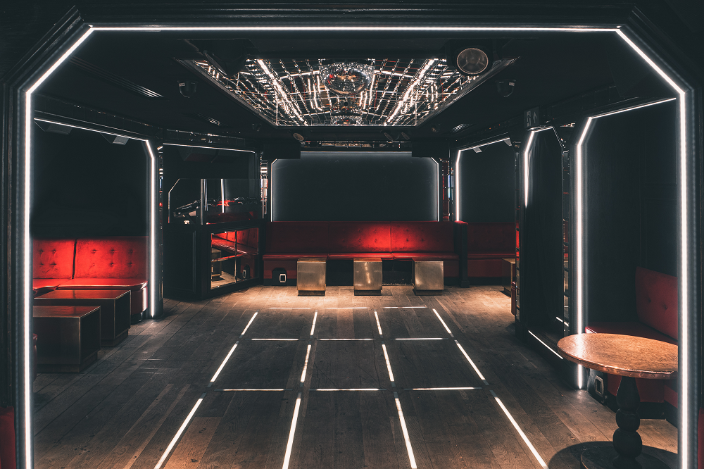 Modern event space at The Scotch of St James with plush red seating for gatherings.