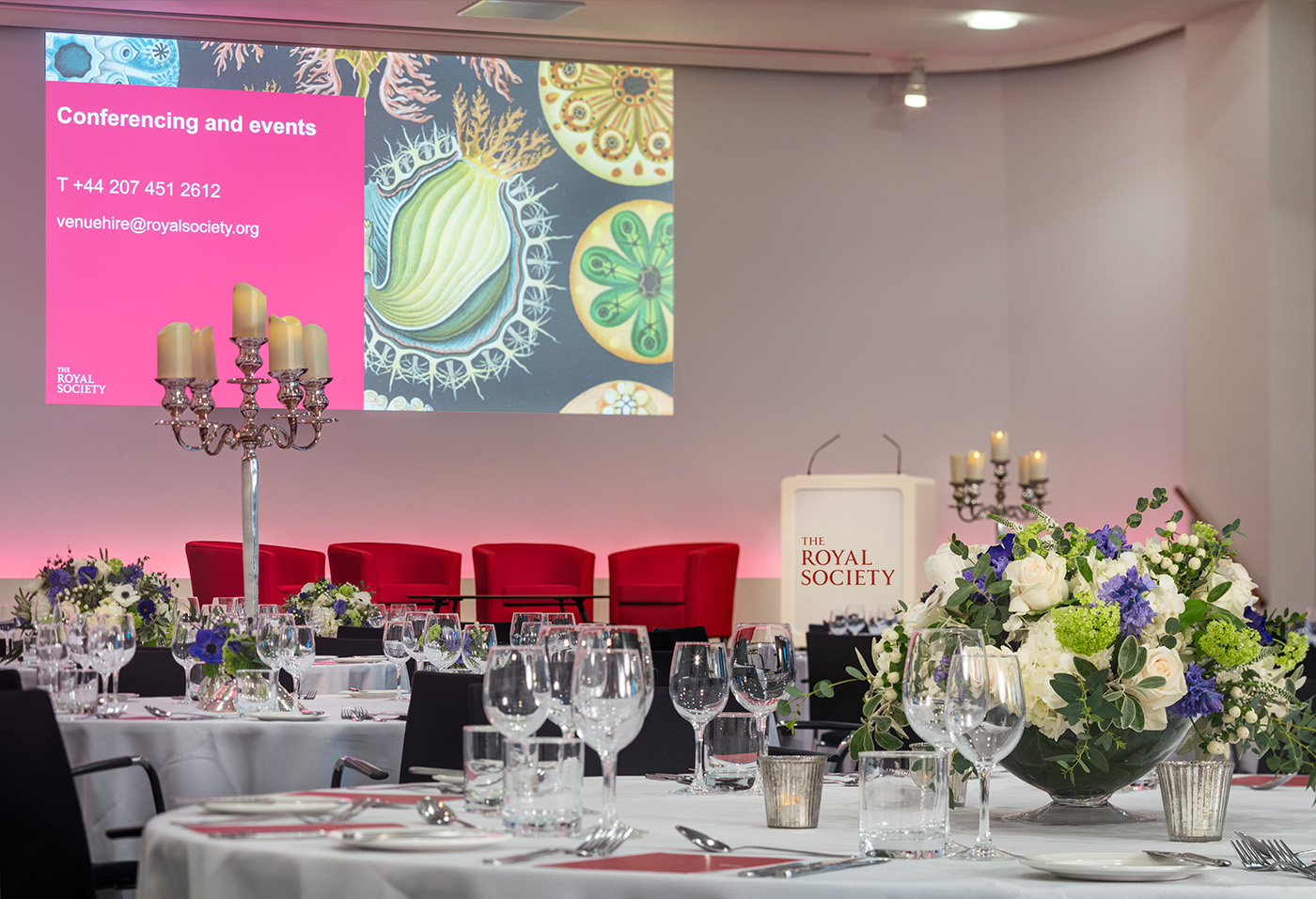 Wellcome Trust Lecture Hall setup for elegant conferences with fine dining and floral decor.