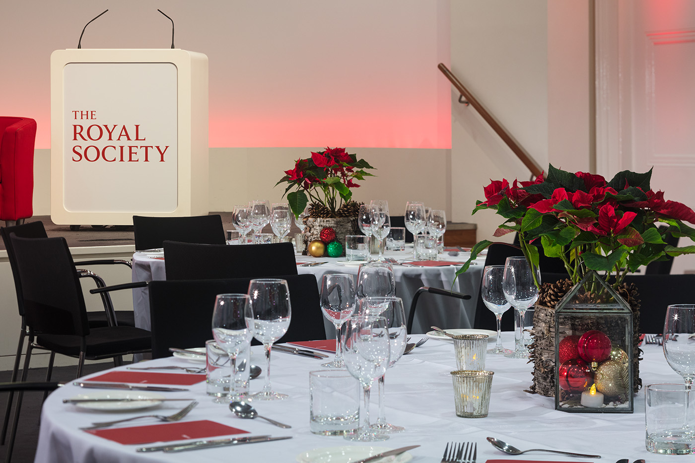 Wellcome Trust Lecture Hall set for a formal event with elegant dining and festive decor.