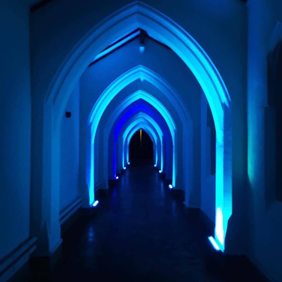 Great Nave corridor in The Monastery Manchester, elegantly lit for events and receptions.