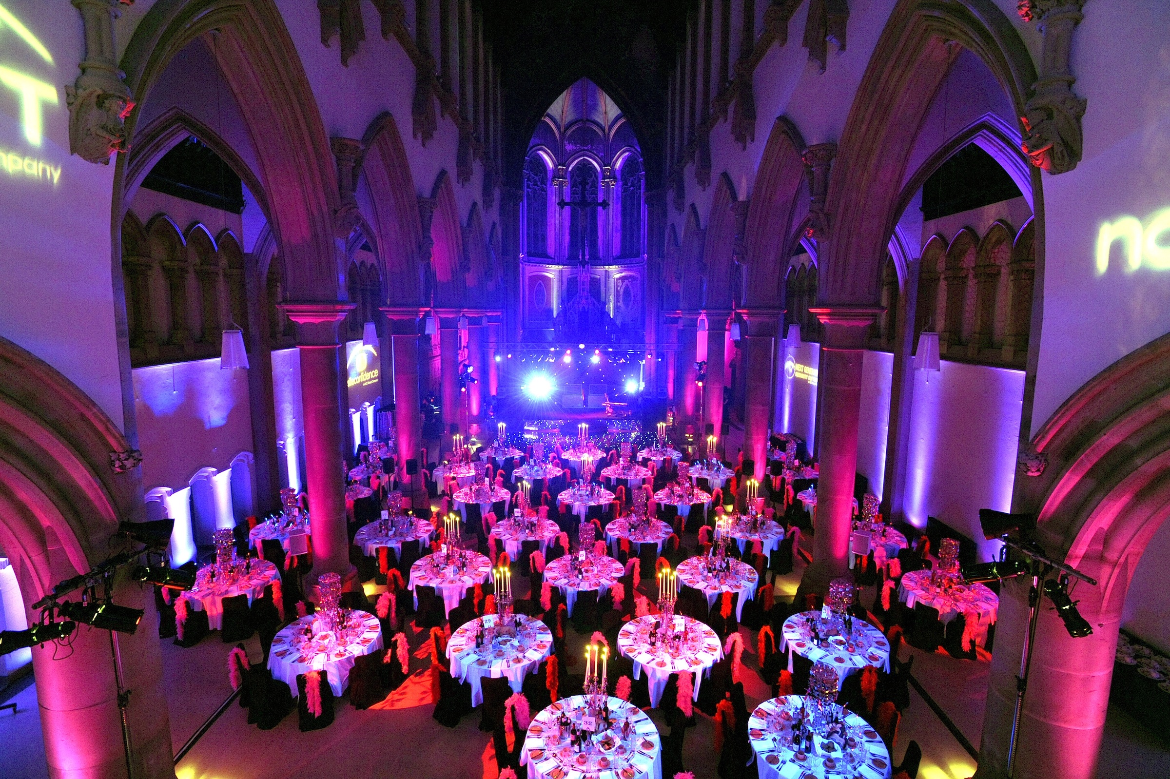 Great Nave, Monastery Manchester: elegant dinner setup with vibrant tables for events.