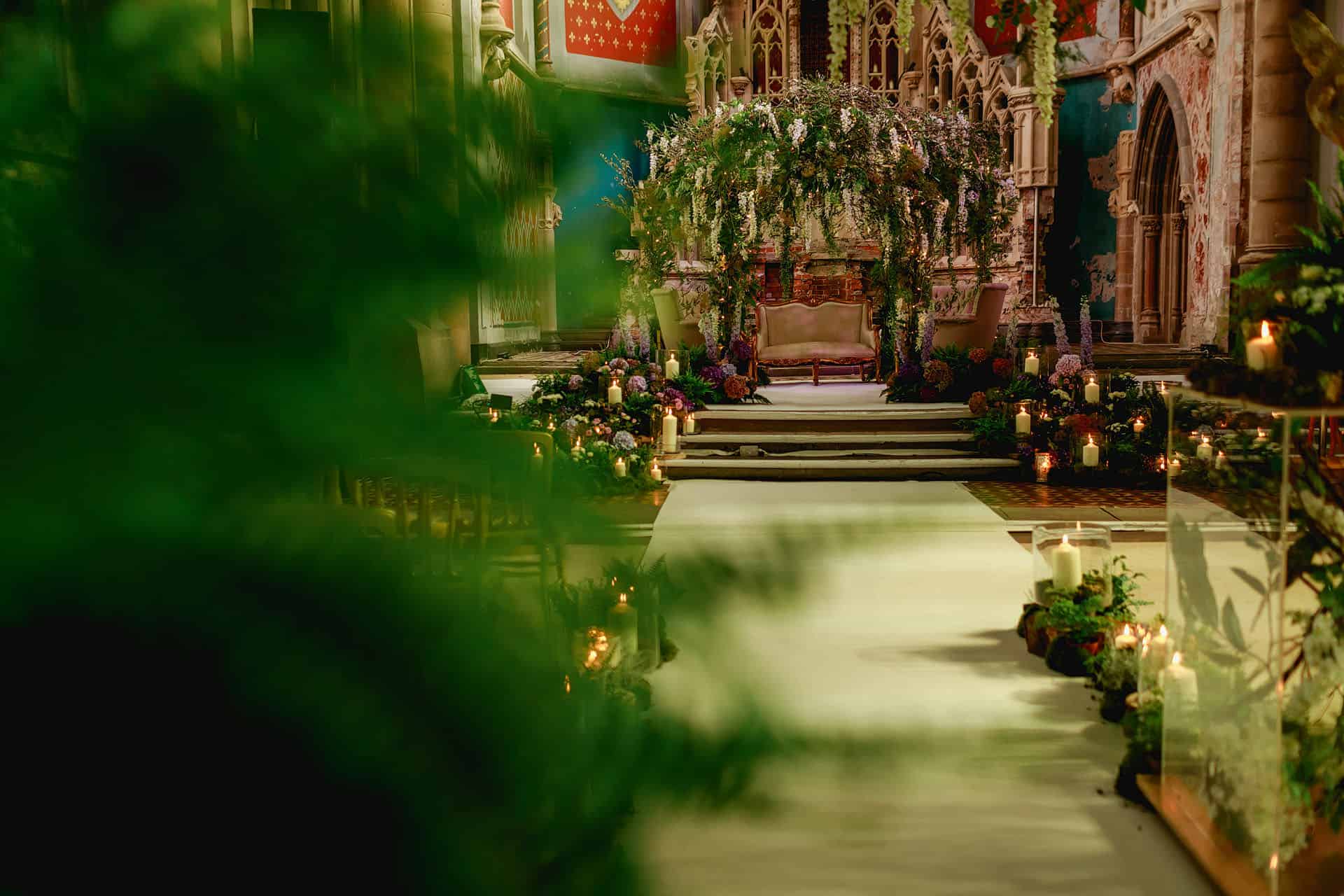 Elegant wedding venue in Great Nave, The Monastery Manchester with lush floral decor.