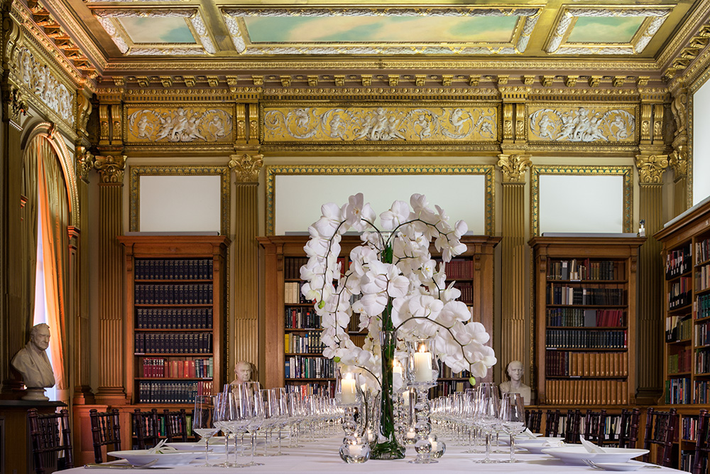 Elegant dining table with orchids in The Royal Society for corporate events.
