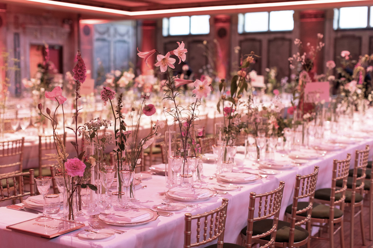 Elegant banquet table with floral arrangements in Shoreditch Town Hall for weddings.