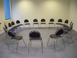 Circular chair arrangement in The Training Room, Naz Project London for team discussions.