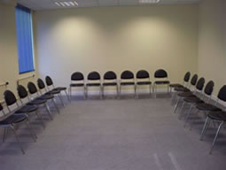 Circular black chairs in a neutral room for engaging meetings and workshops.