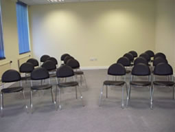 Meeting room in Naz Project London with black chairs for workshops and discussions.