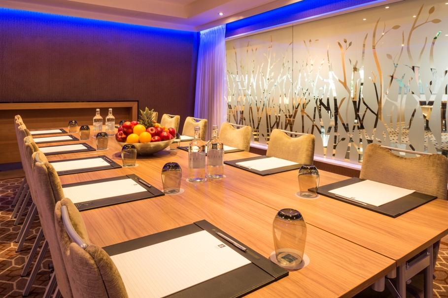 Private dining room at Chelsea Harbour Hotel with wooden table, ideal for meetings and events.