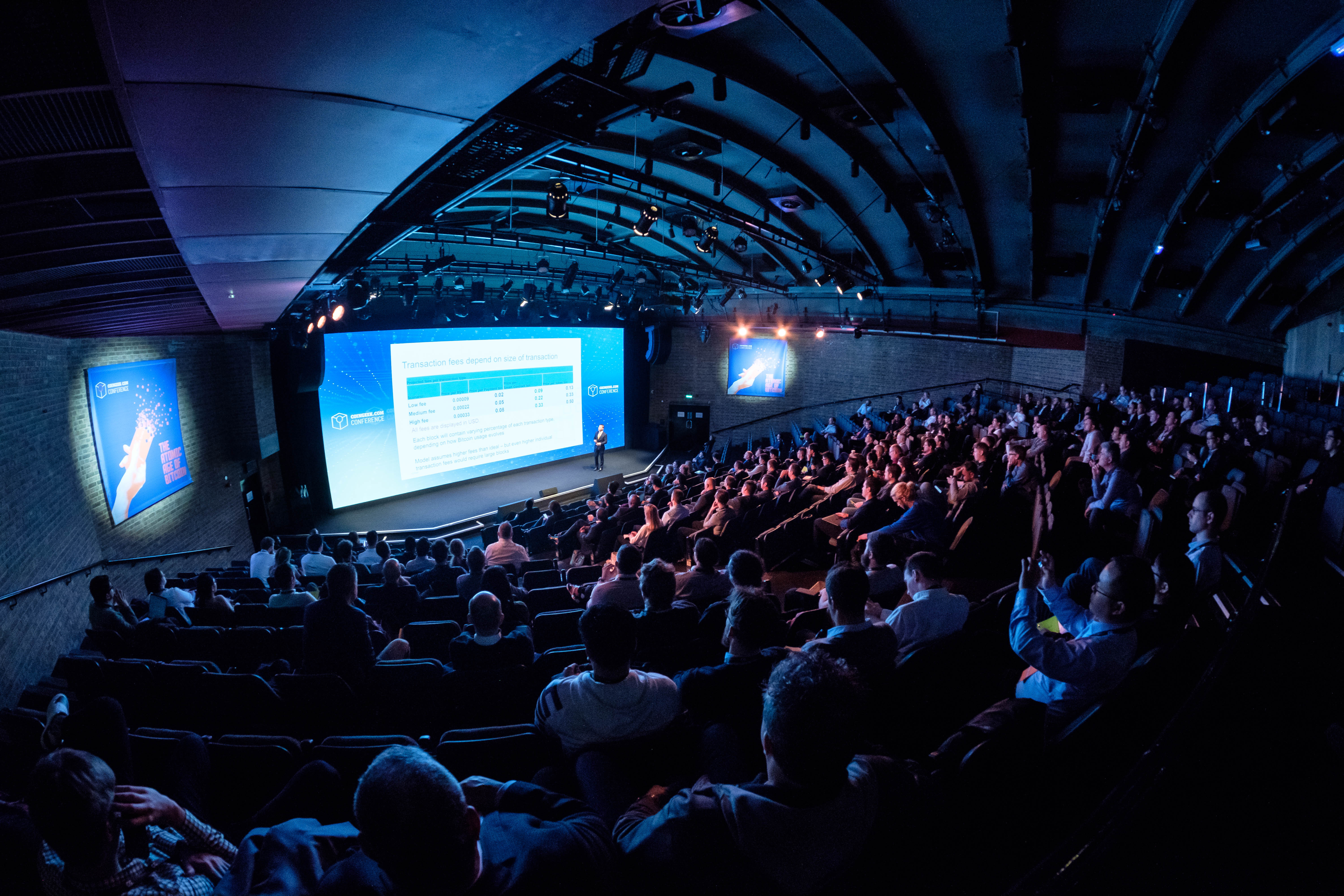 "Engaged audience at a modern conference in The Mermaid London auditorium."