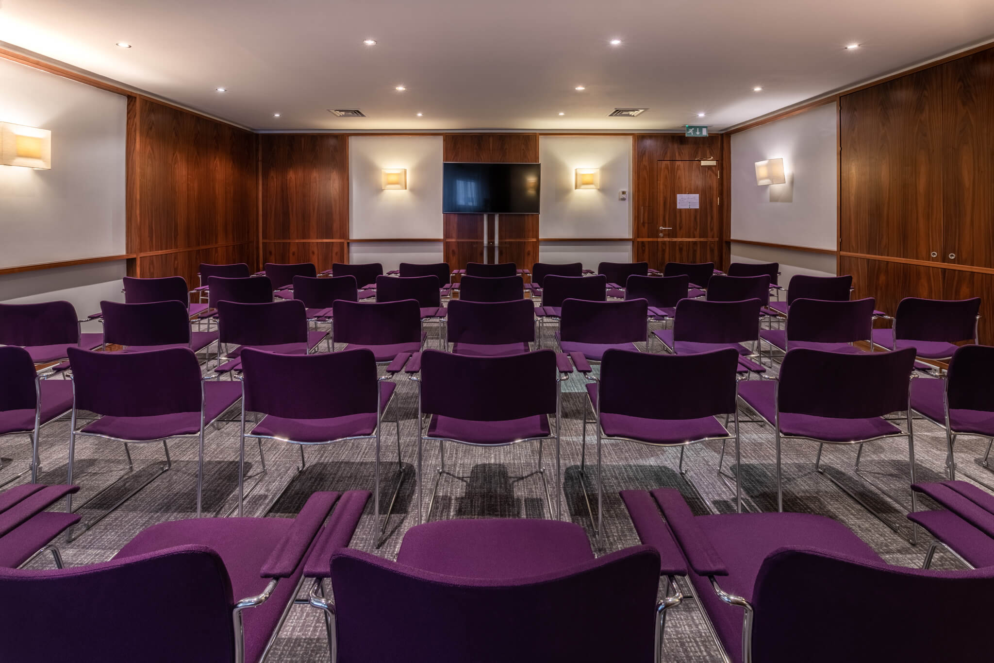Conference Room Nevern with sleek purple chairs, ideal for meetings and workshops.