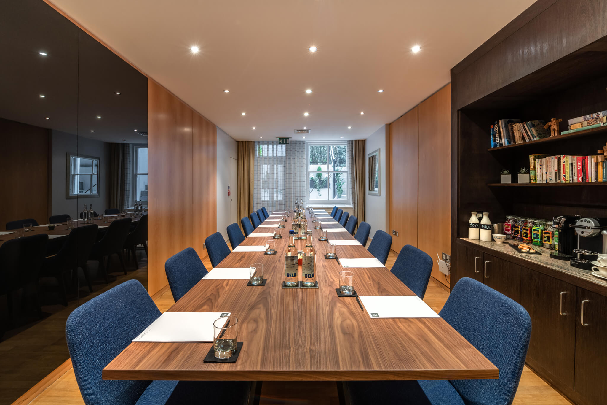 Boardroom at K+K Hotel George, ideal for workshops and strategy sessions, features a long wooden table.