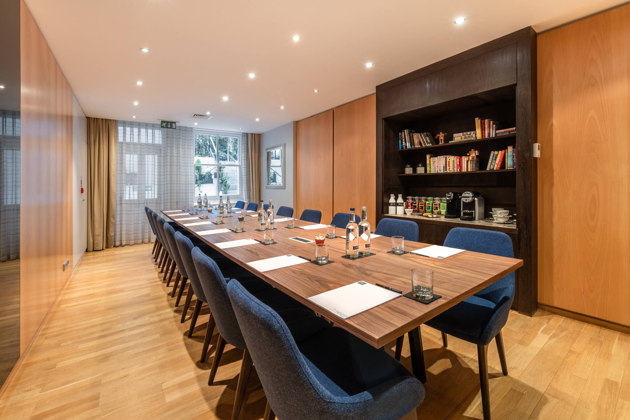The Boardroom at K+K Hotel George, featuring a long wooden table for meetings.