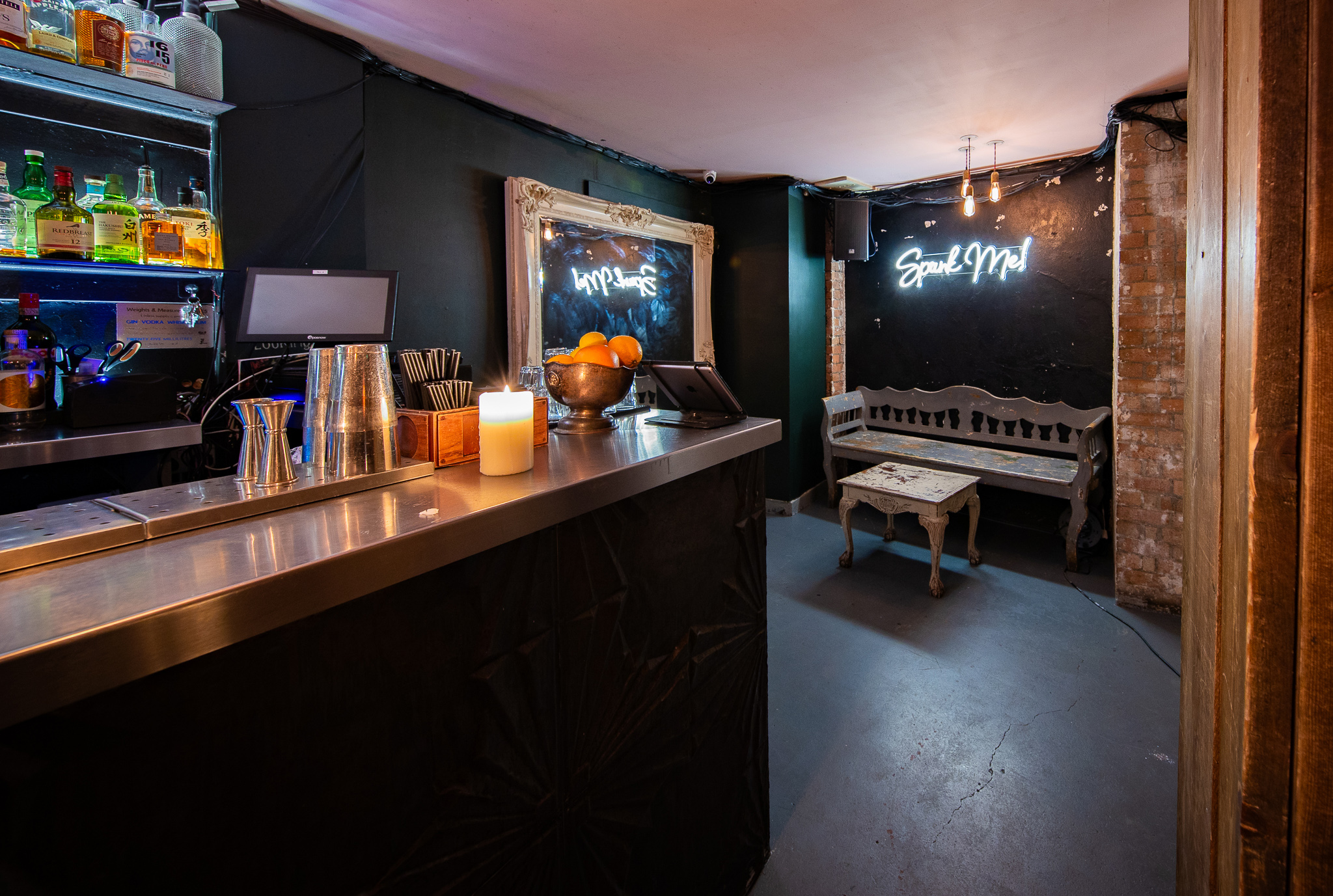 Intimate bar venue with sleek counter, perfect for private events and gatherings.
