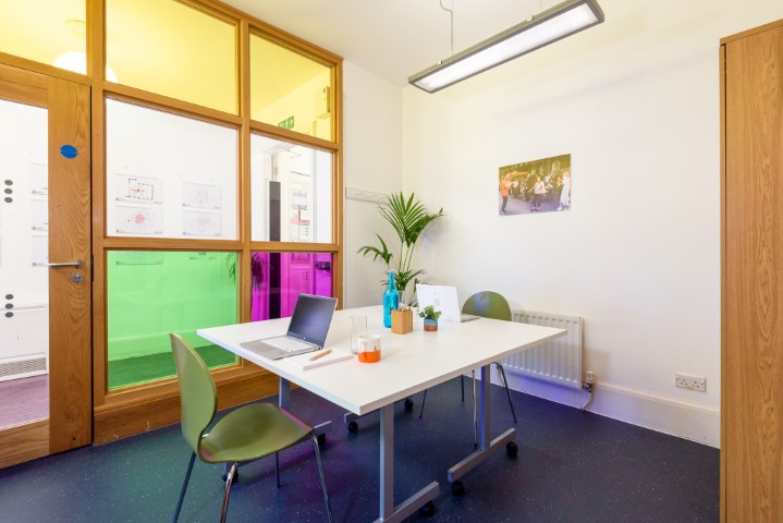 Modern meeting room in Fitzrovia Centre, vibrant glass partitions, ideal for brainstorming sessions.