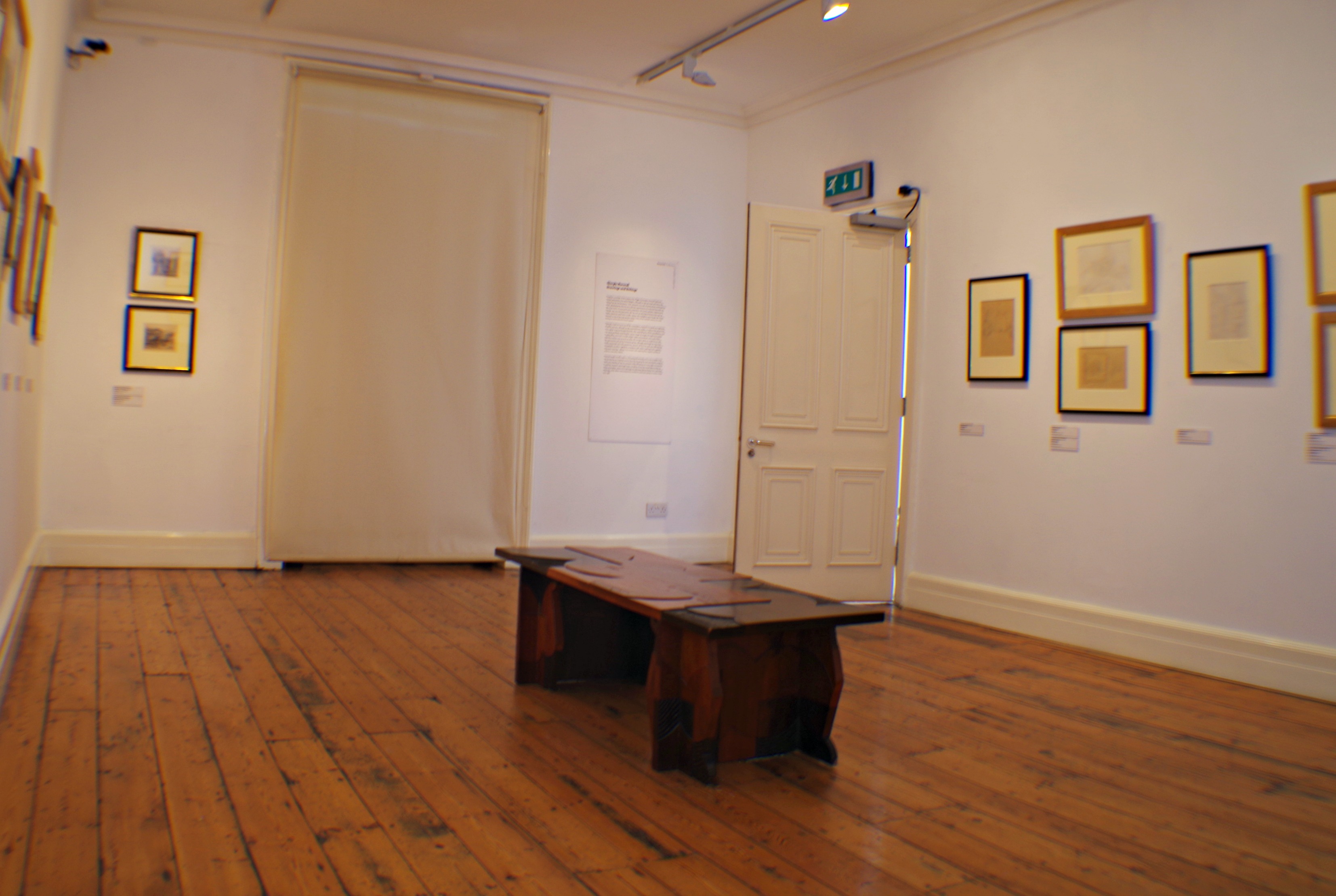 Minimalist gallery space with wall art, ideal for intimate art events and meetings.