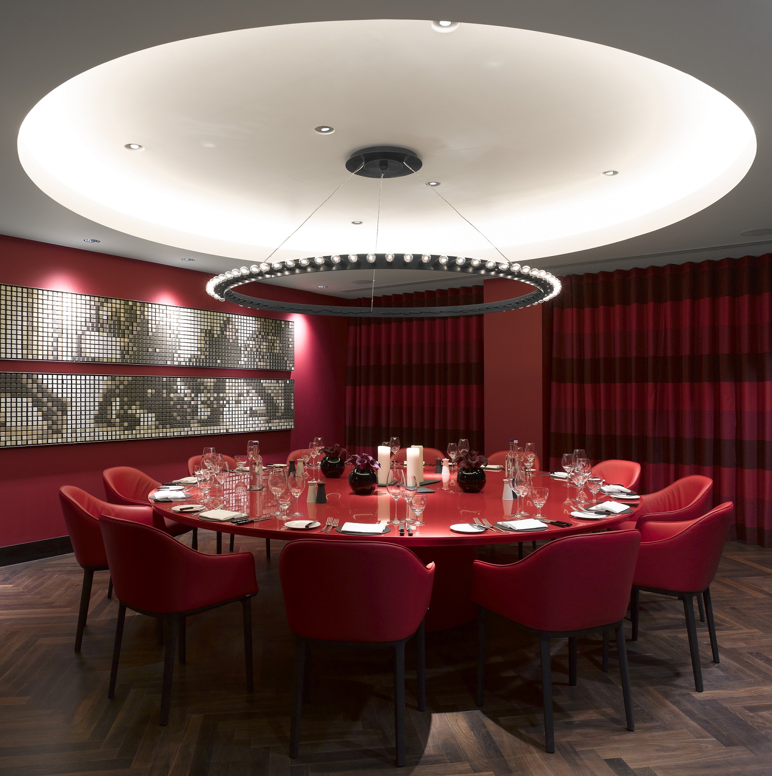 Sophisticated meeting space at South Place Hotel with round table and vibrant red decor.