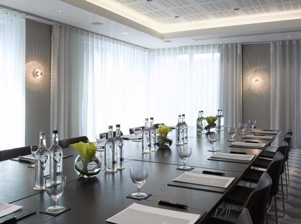 Modern meeting room at South Place Hotel with elegant table setup for corporate events.