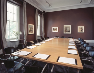 Orpen Boardroom at IWM London, featuring a polished table for professional meetings.
