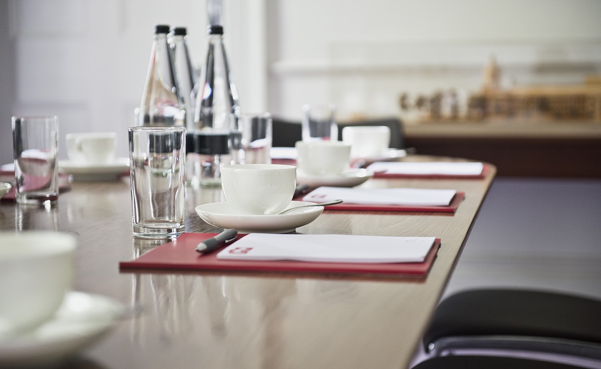 Meeting Room 1 at IWM London with polished table, notepads for professional meetings.