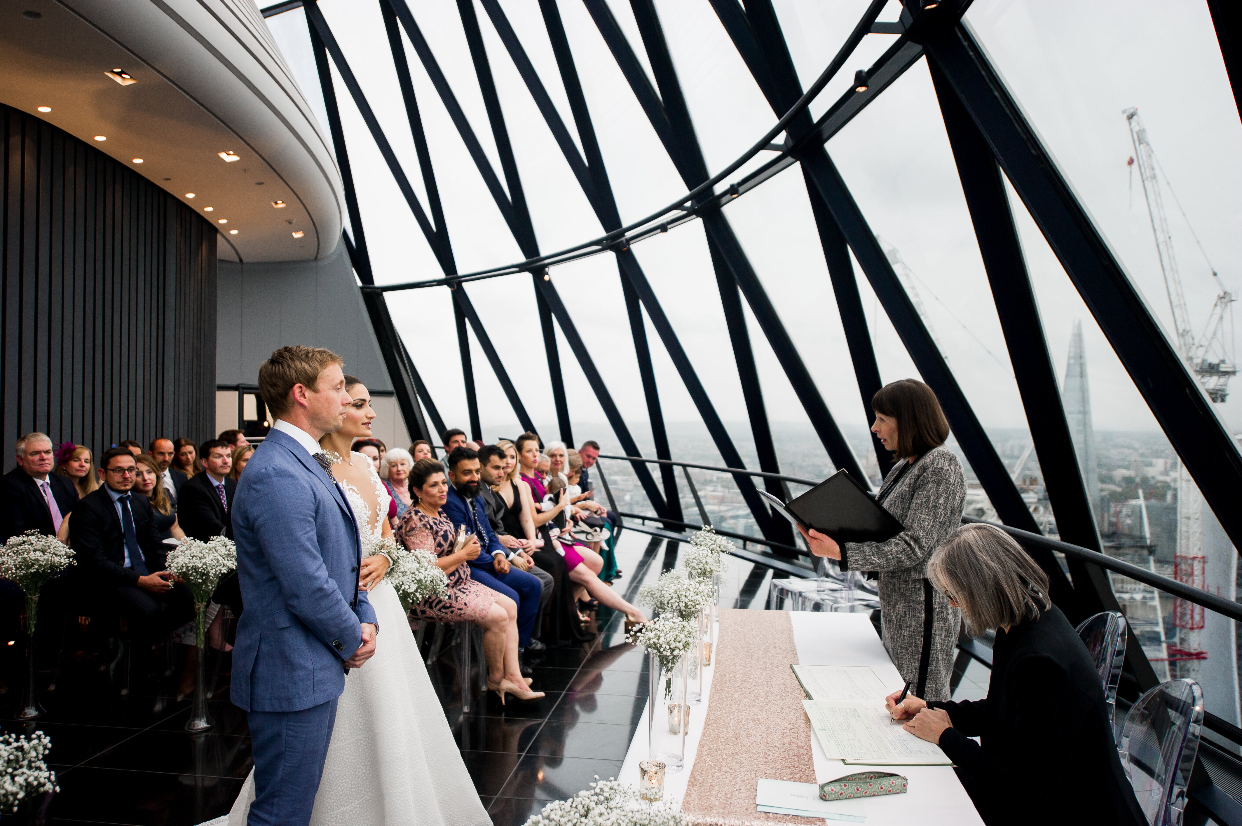 Modern wedding ceremony at Searcys Gherkin with city views and elegant decor.