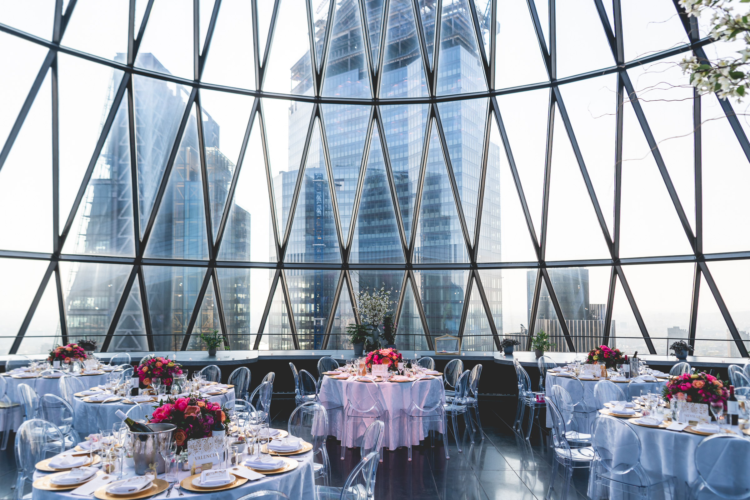 Elegant event space at Searcys Gherkin with floral centerpieces for corporate events or weddings.