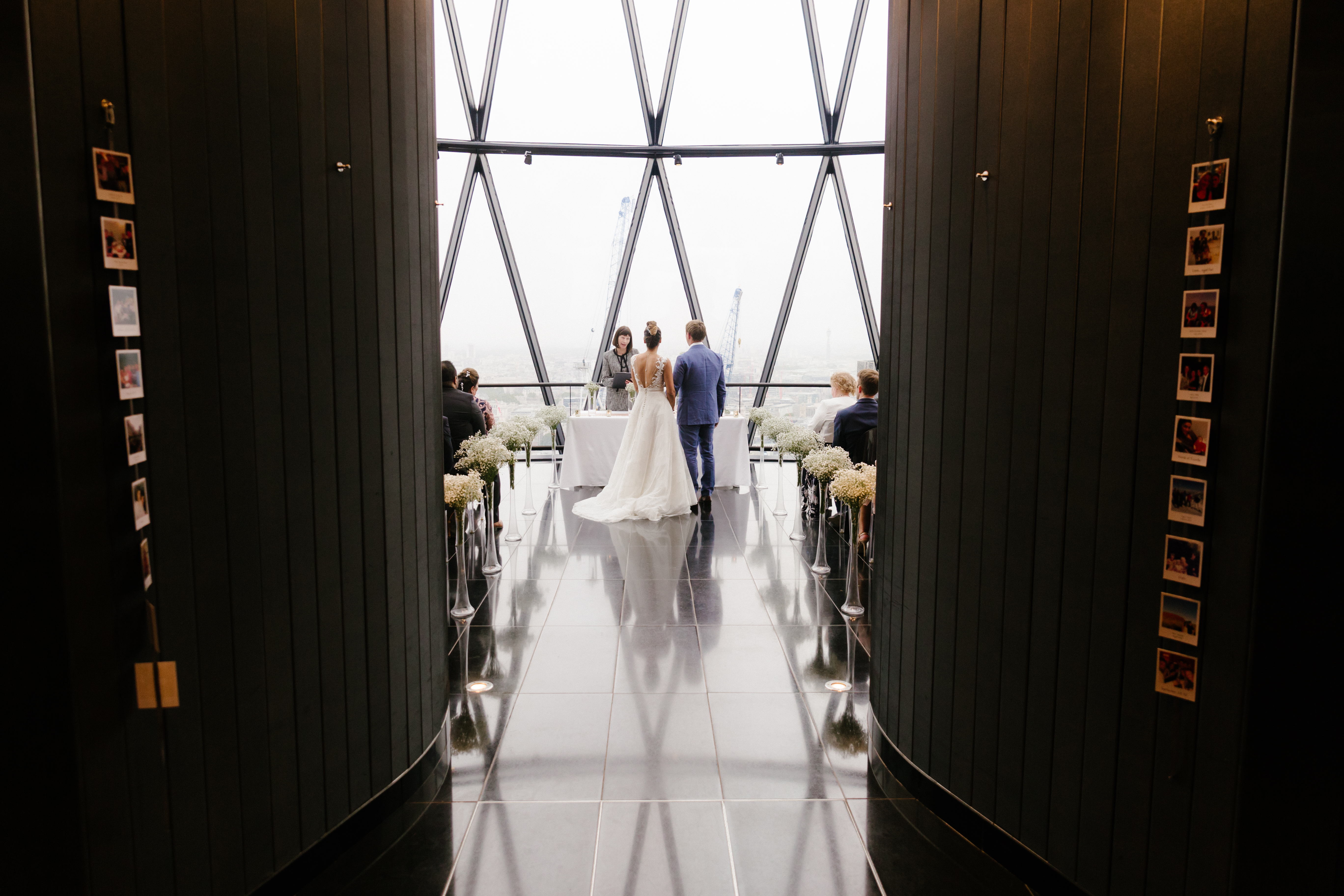 Elegant wedding ceremony at Searcys in the Gherkin with modern architecture and soft lighting.