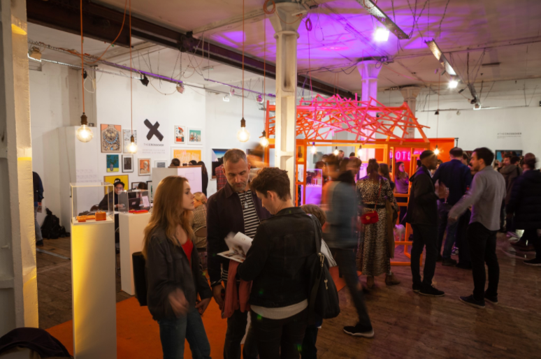 Networking event at Candid Arts Trust with vibrant decor and colorful lighting.