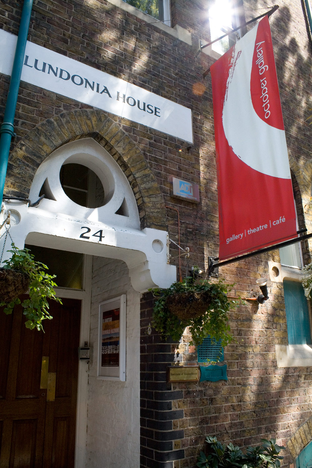 Charming venue entrance with greenery for intimate meetings and art exhibitions.