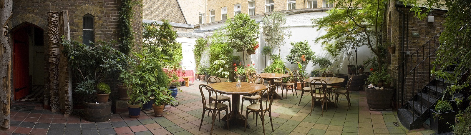 Charming outdoor venue with lush greenery for intimate gatherings and networking events.