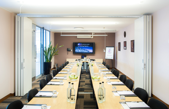 Medium Meeting Room with long table, ideal for professional events and presentations.