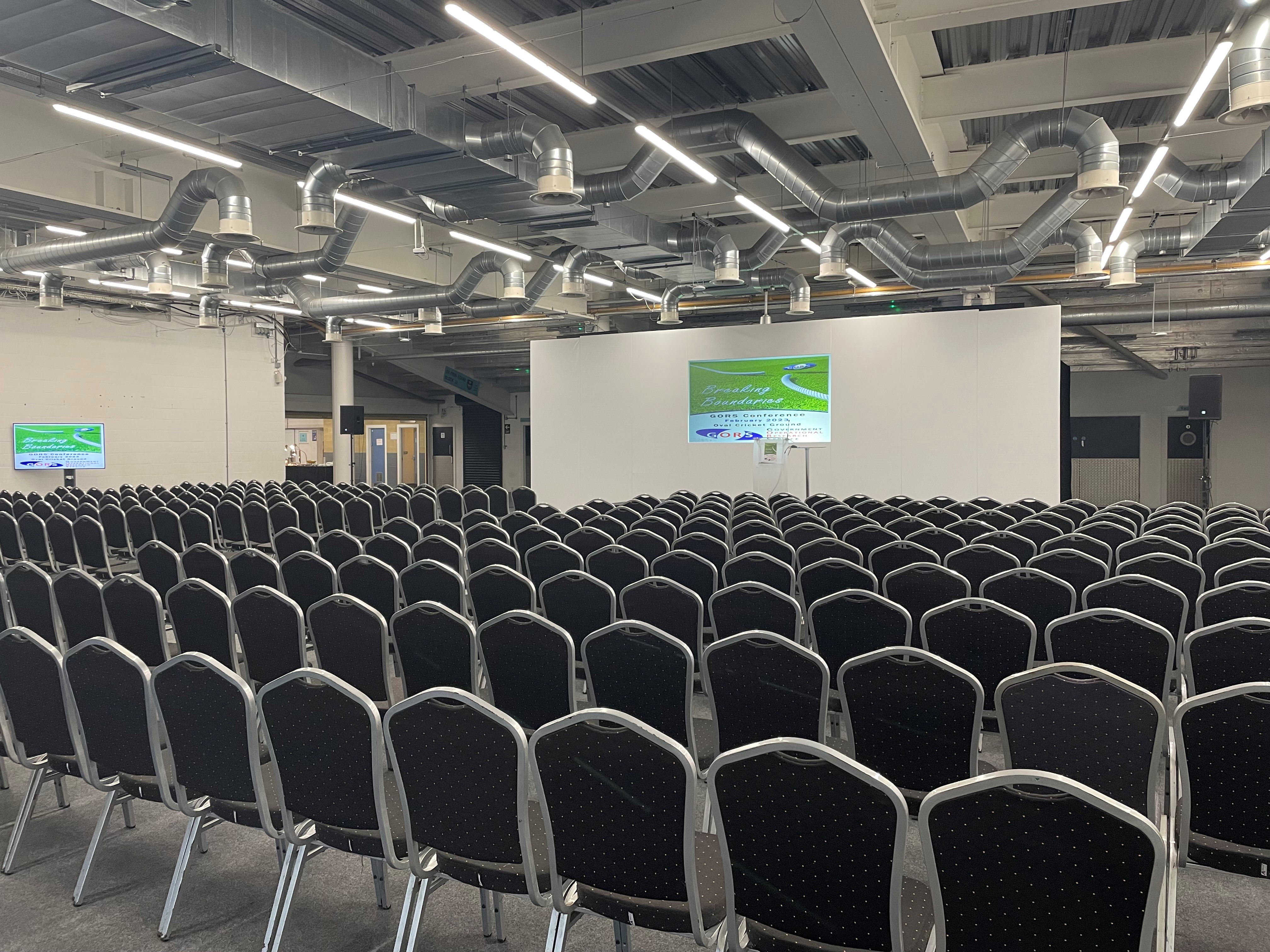 Jardine Suite at Kia Oval, spacious conference room for events with black chairs.