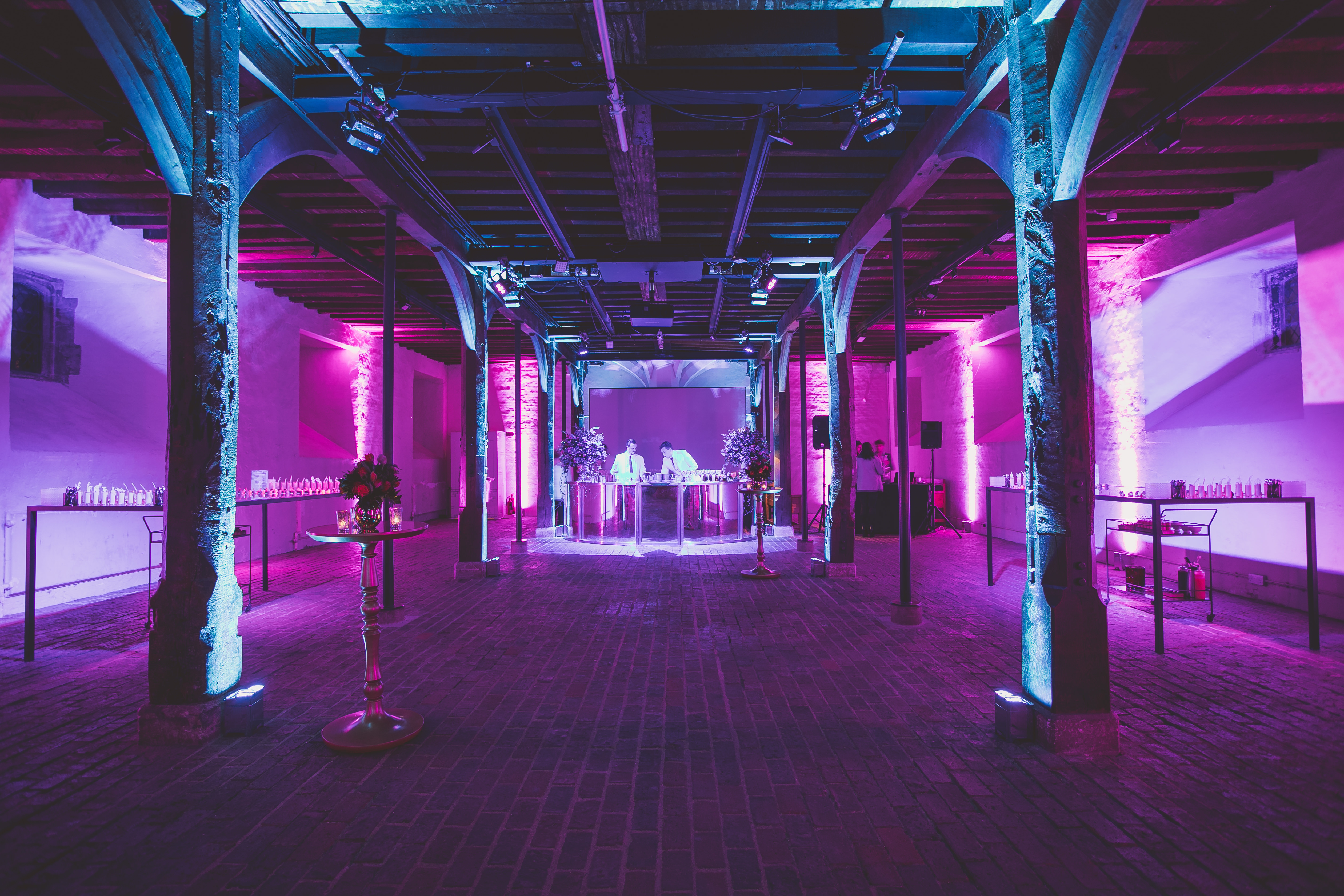 Stylish event space in Hampton Court Palace with purple lighting for corporate events.