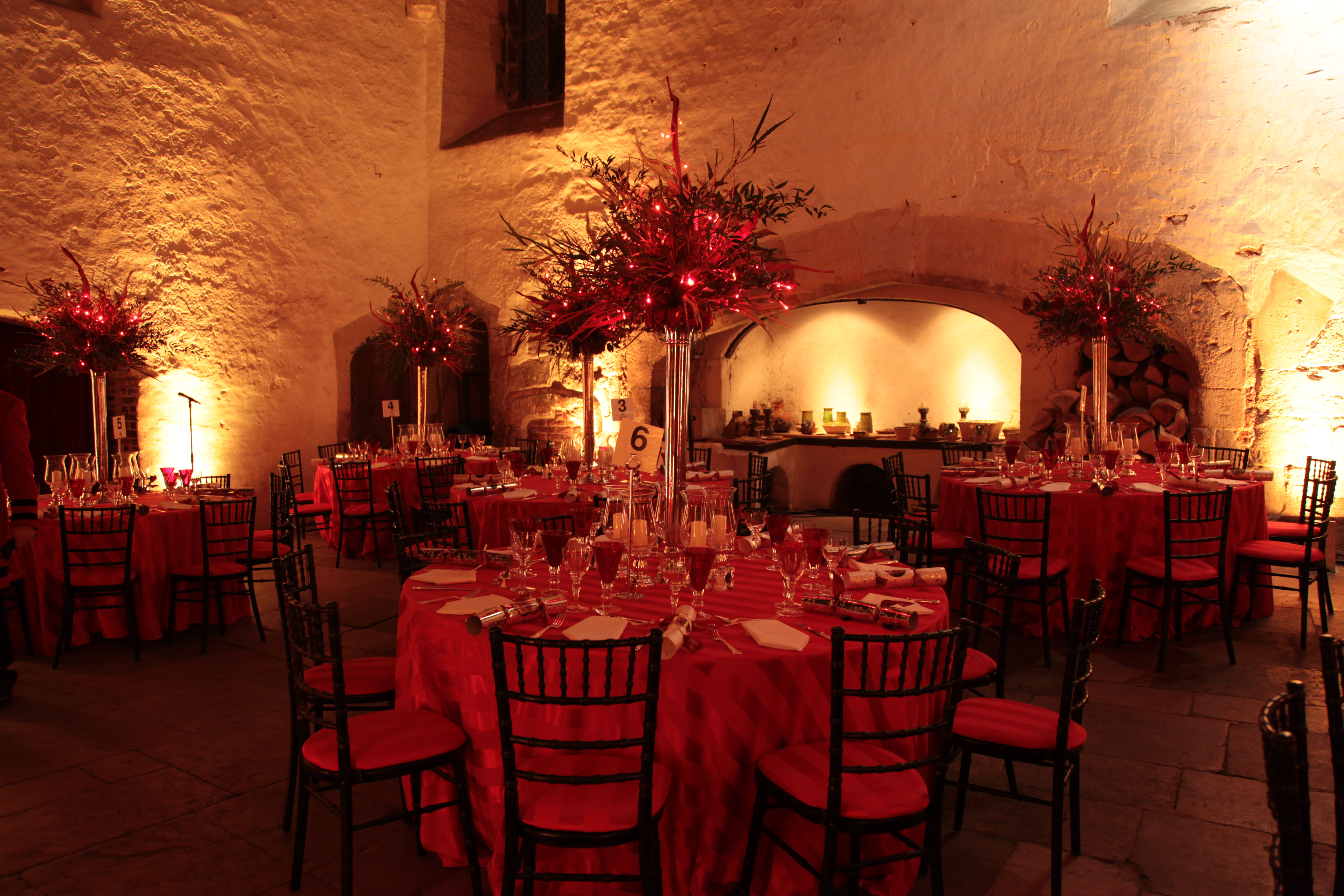 Elegant event space in Hampton Court Palace with red tablecloths for a gala dinner.