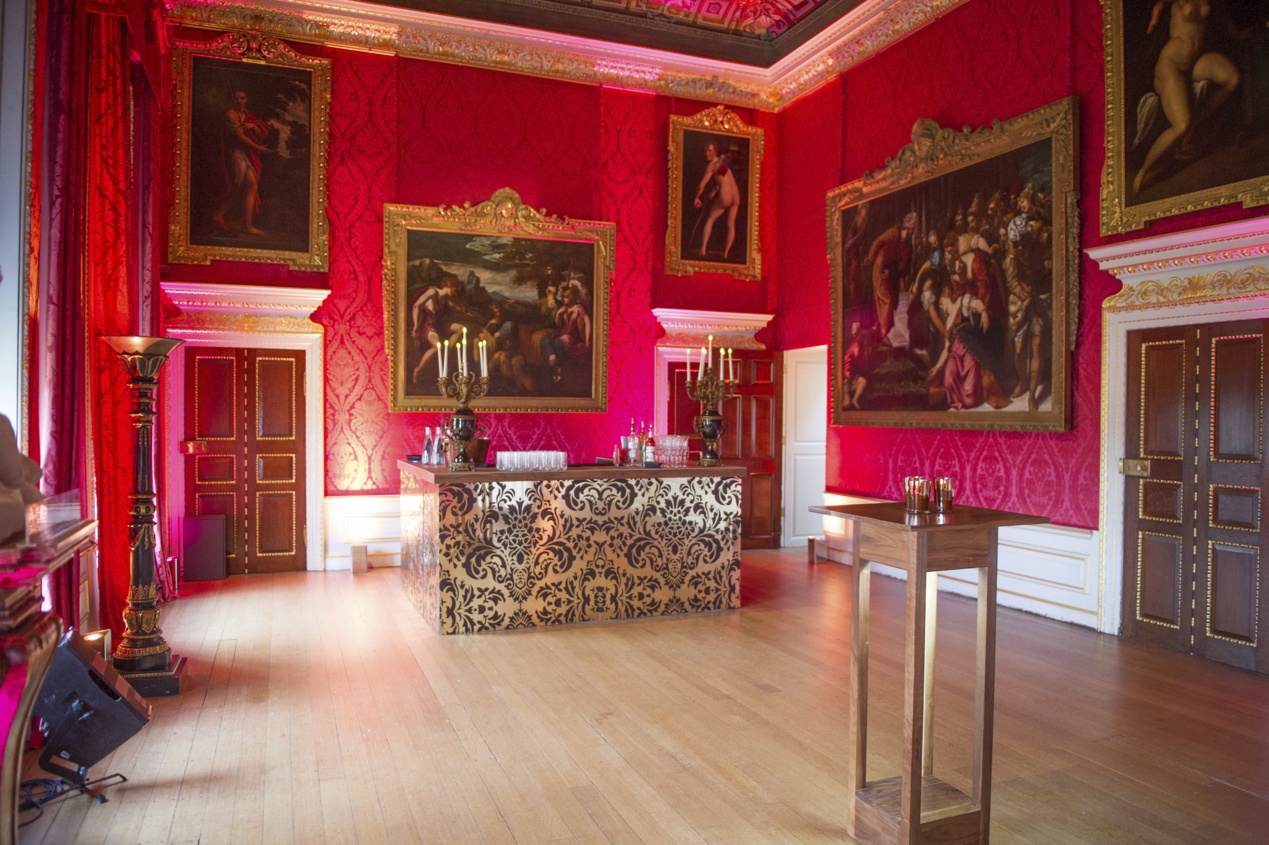 Elegant Kensington Palace State Apartments with rich red walls for upscale events.