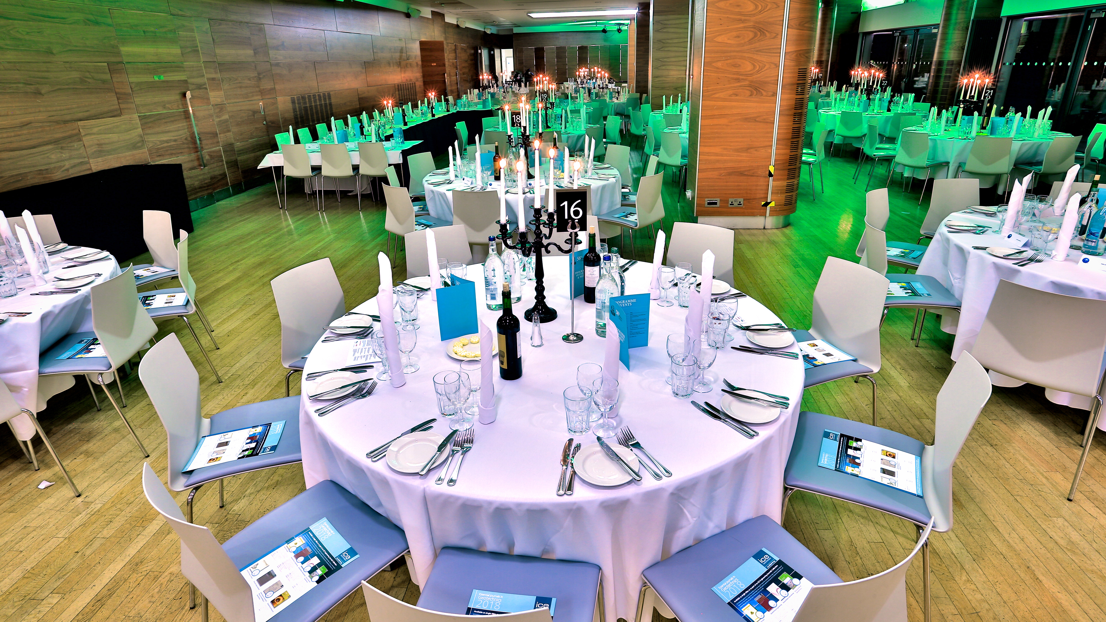 Elegant event space with round tables for a formal dinner at Queen's Tower Rooms.