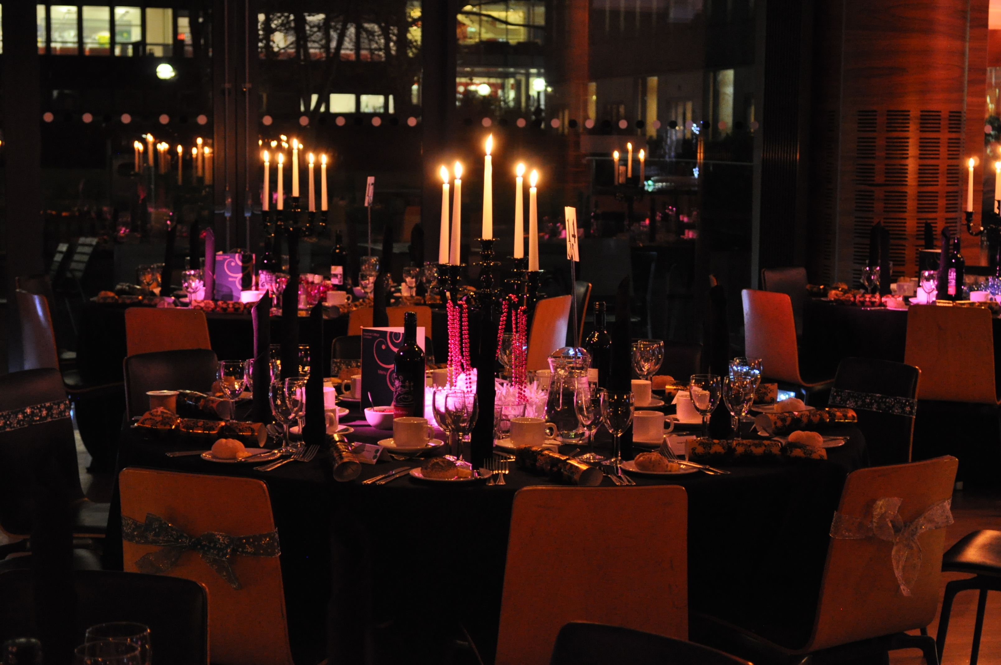Elegant dining area with black tablecloths for a formal gala at Queen's Tower Rooms.
